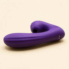 Sucking Sweet in purple silicone lying on its side on a cream ground