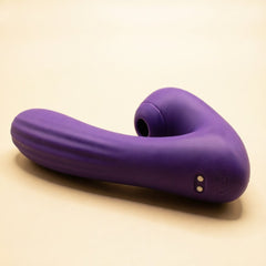 Close view of Sucking Sweet in purple silicone on a cream ground