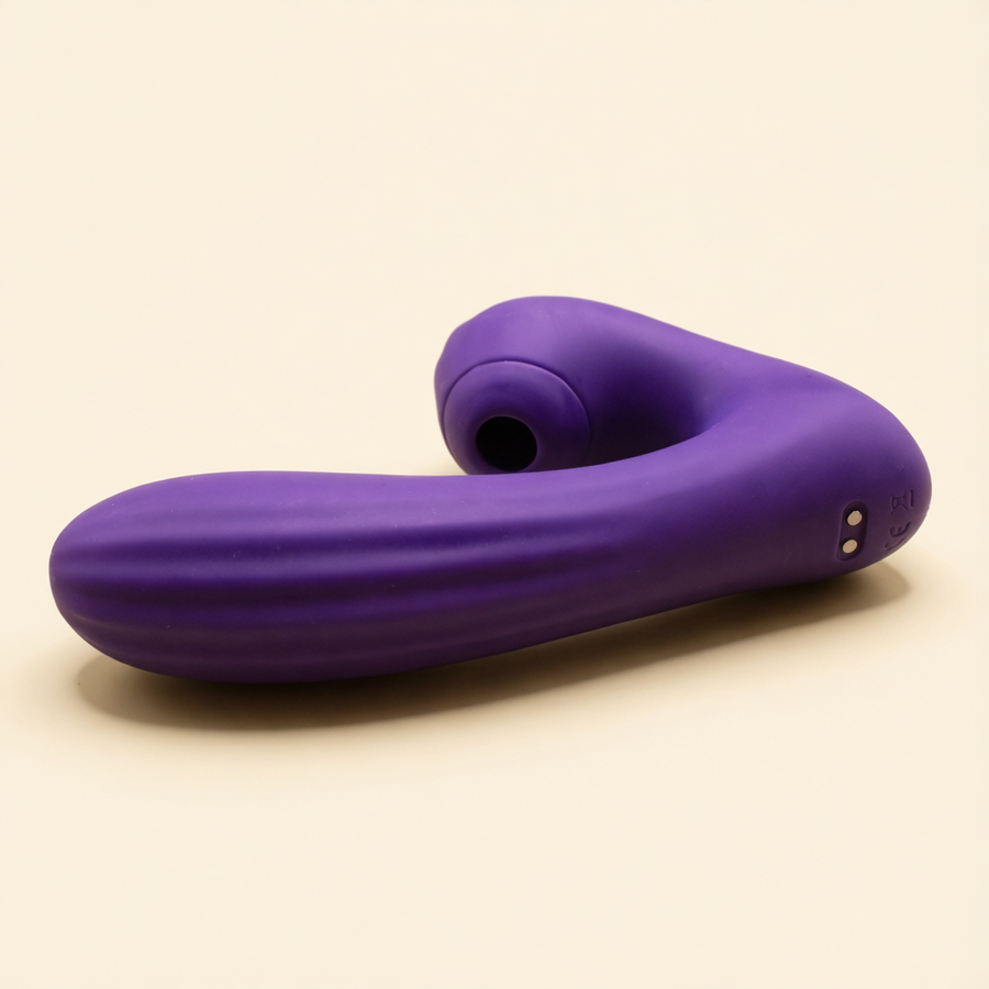 Sucking Sweet in purple silicone lying on its side on a cream ground
